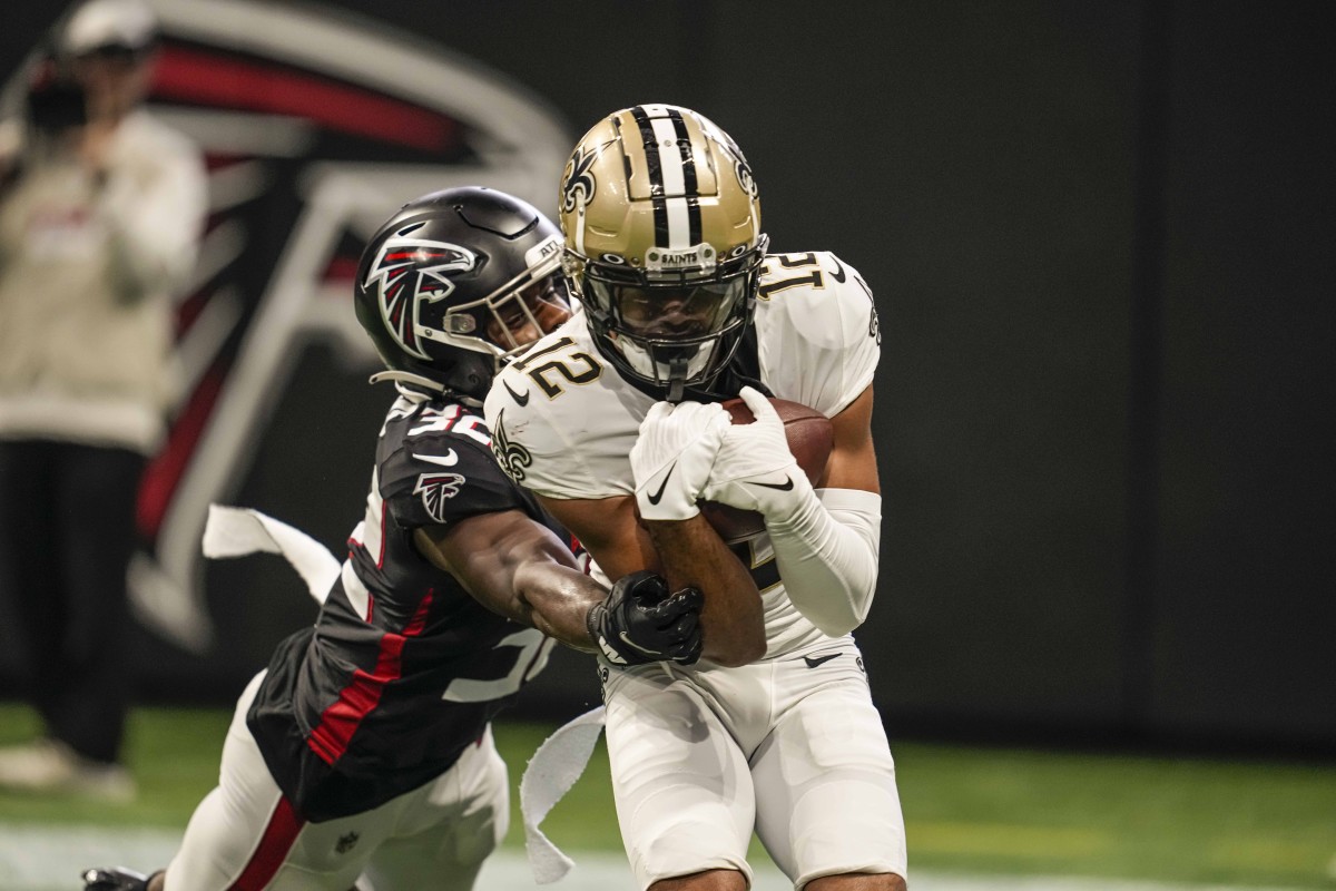 Sep 11, 2022; New Orleans Saints wide receiver Chris Olave (12) catches a two point conversion in front of Atlanta Falcons safety Jaylinn Hawkins (32). Mandatory Credit: Dale Zanine-USA TODAY Sports